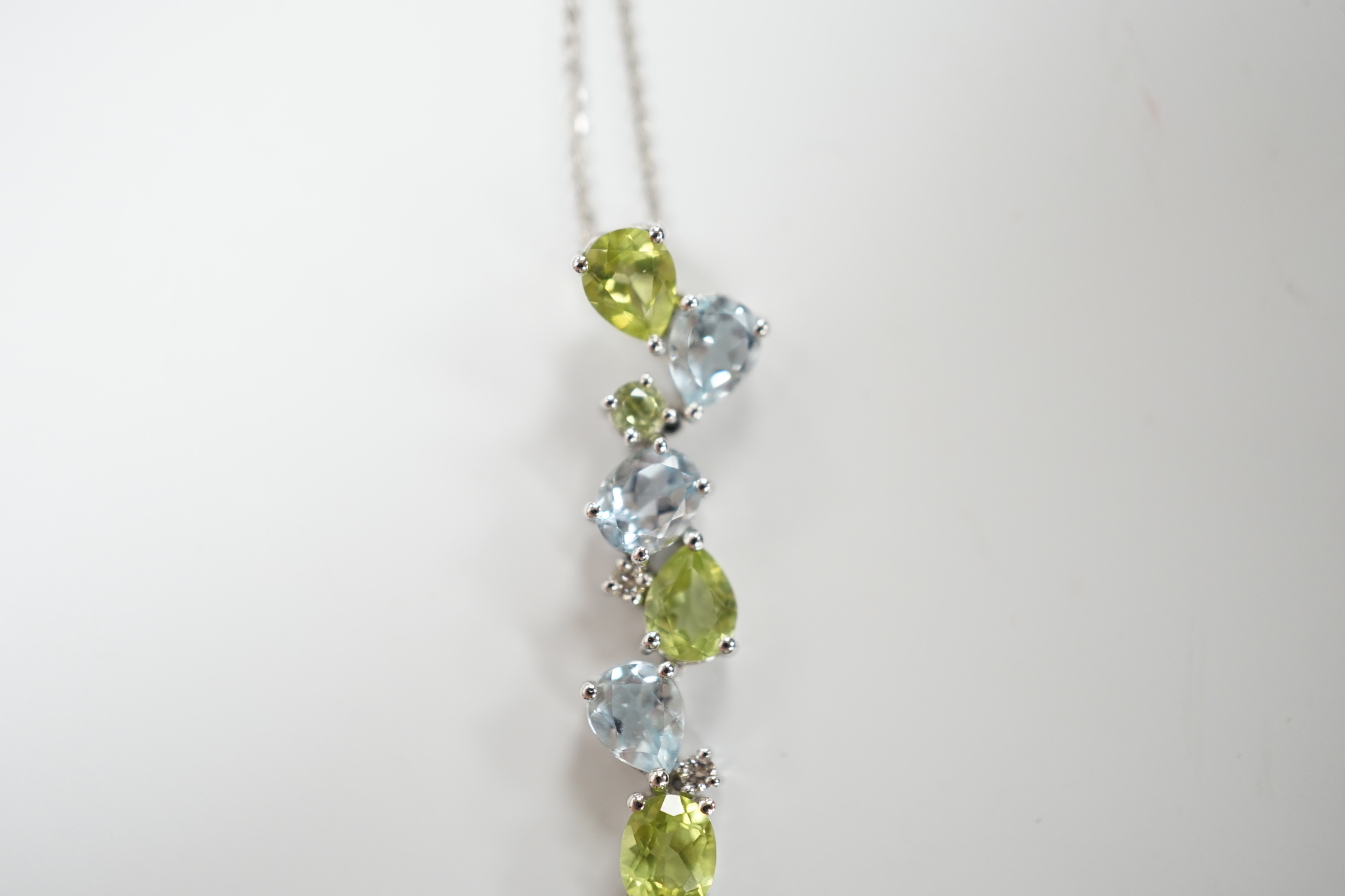 A modern 9ct white gold, peridot and blue topaz set pendant, 37mm, on a 375 chain, 40cm, gross weight 3.4 grams.